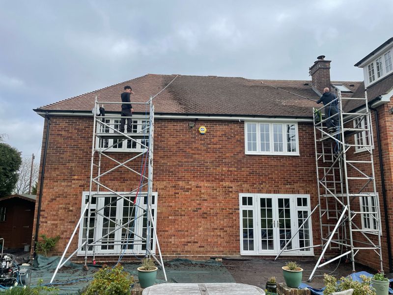 Roof cleaning carried out safely from scaffold towers by The Roof Moss Cleaners in Midhurst